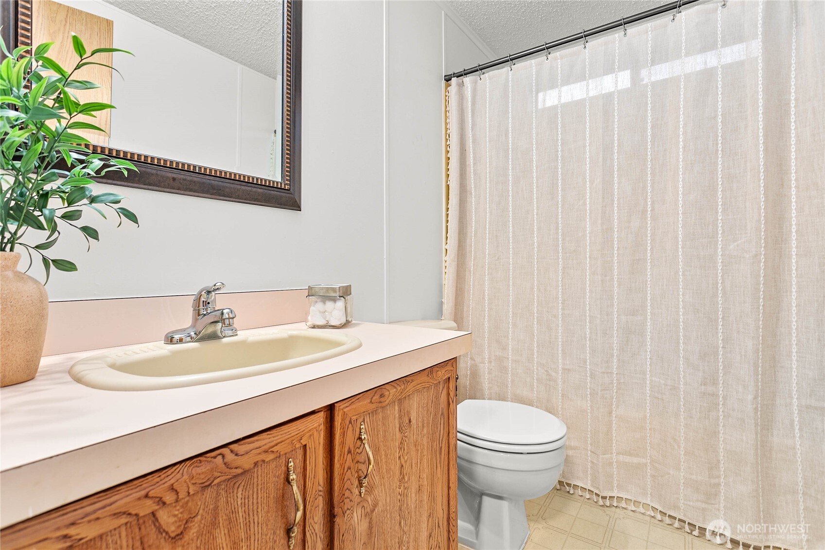 7343 Hannegan Road, Unit 2 Lynden, WA 98264 - Photo 27 of 34 a bathroom with a sink a toilet and a mirror