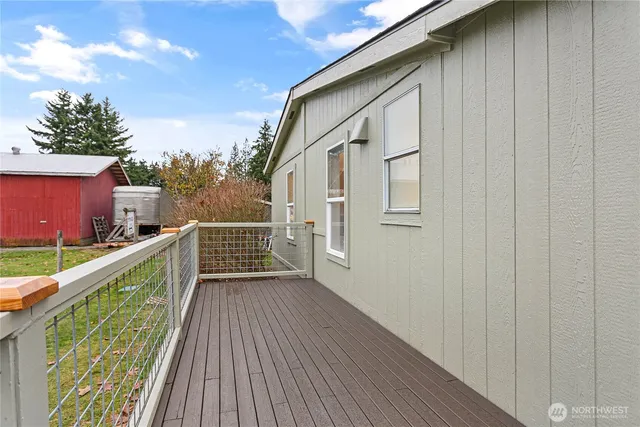 a view of balcony with wooden floor and fence