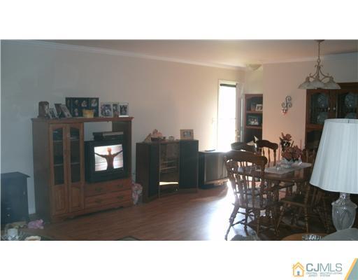 175 Penn Court Old Bridge, NJ 07747 - Photo 2 of 5 a living room with furniture a dining table and a potted plant