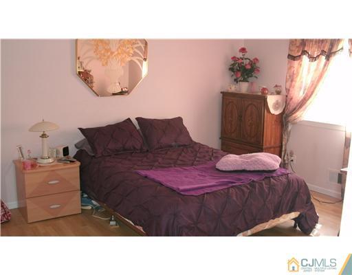 175 Penn Court Old Bridge, NJ 07747 - Photo 5 of 5 a bedroom with a bed and a painting on the wall