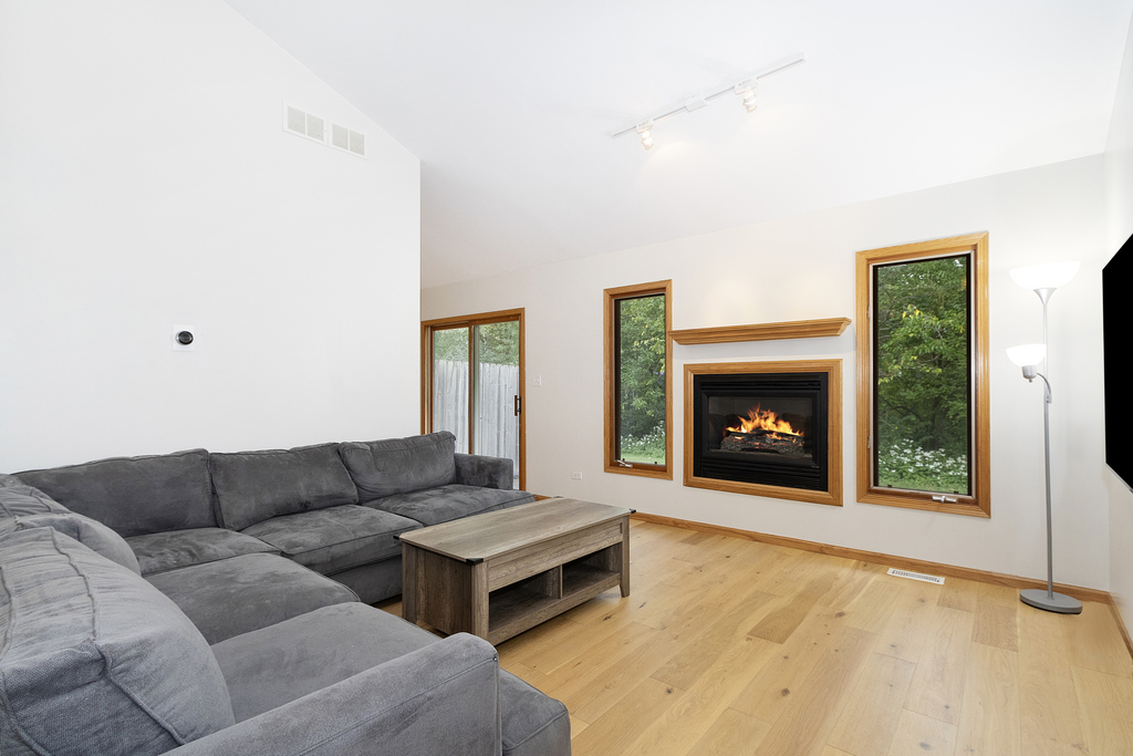 126 Twilight Lane New Lenox, IL 60451 - Photo 3 of 15 a living room with furniture and a fireplace