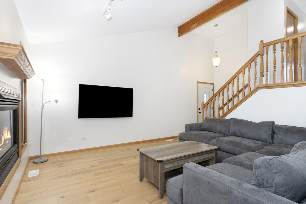 126 Twilight Lane New Lenox, IL 60451 - Photo 5 of 15 a living room with couches and a flat screen tv