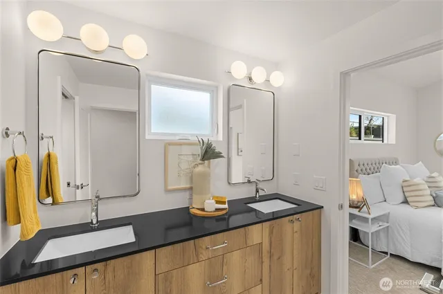 a bathroom with a granite countertop sink and a mirror