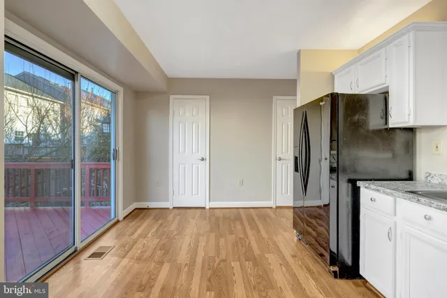 a view of a kitchen with a sink and a refrigerator