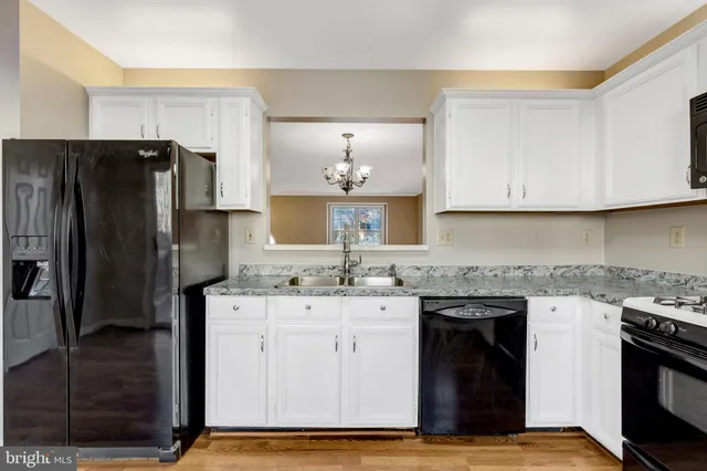 a kitchen with a sink stove and refrigerator