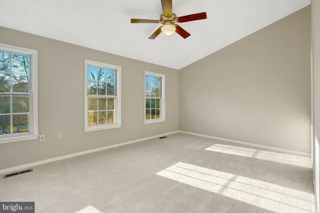 a view of a livingroom with a ceiling fan and window