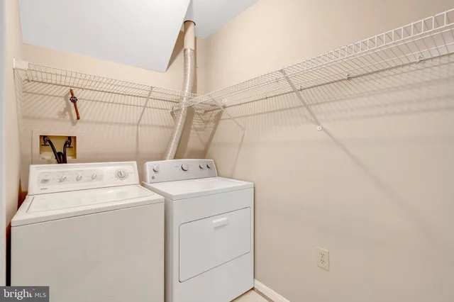 a view of entryway with white walls and door