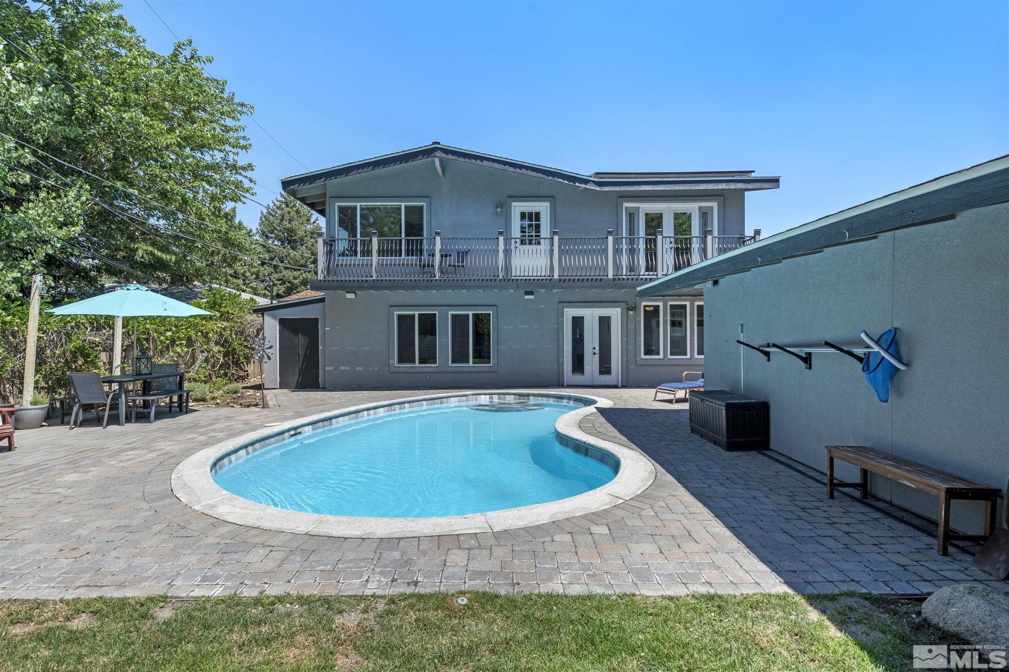 1005 Memory Lane Reno, NV 89509 - Photo 1 of 32 a view of a house with backyard sitting area and swimming pool
