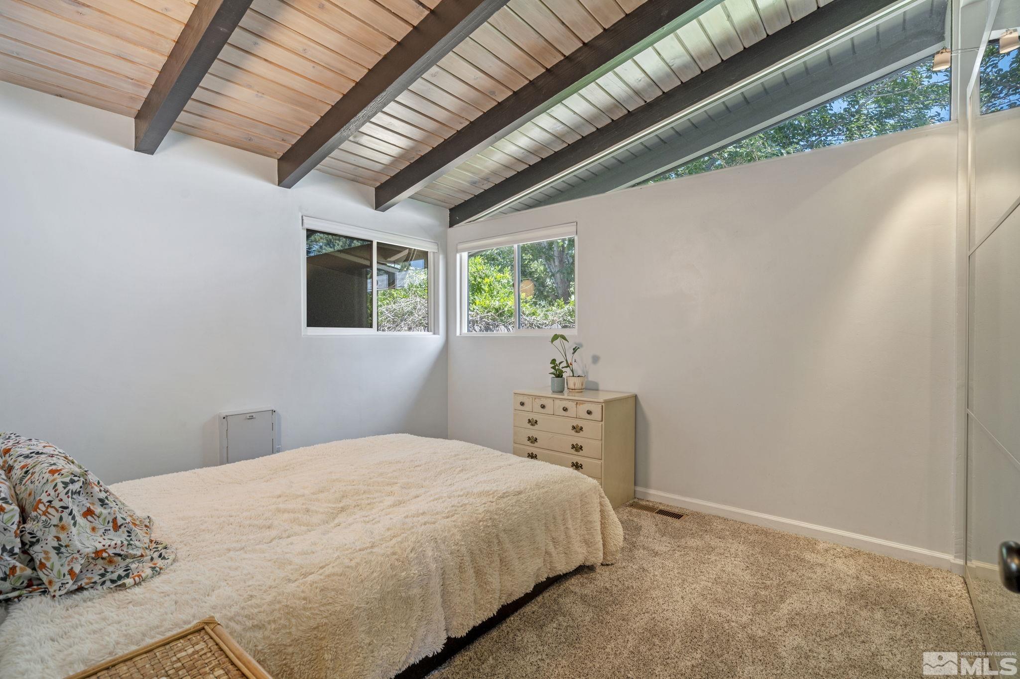 1005 Memory Lane Reno, NV 89509 - Photo 12 of 32 a bedroom with a bed and a window