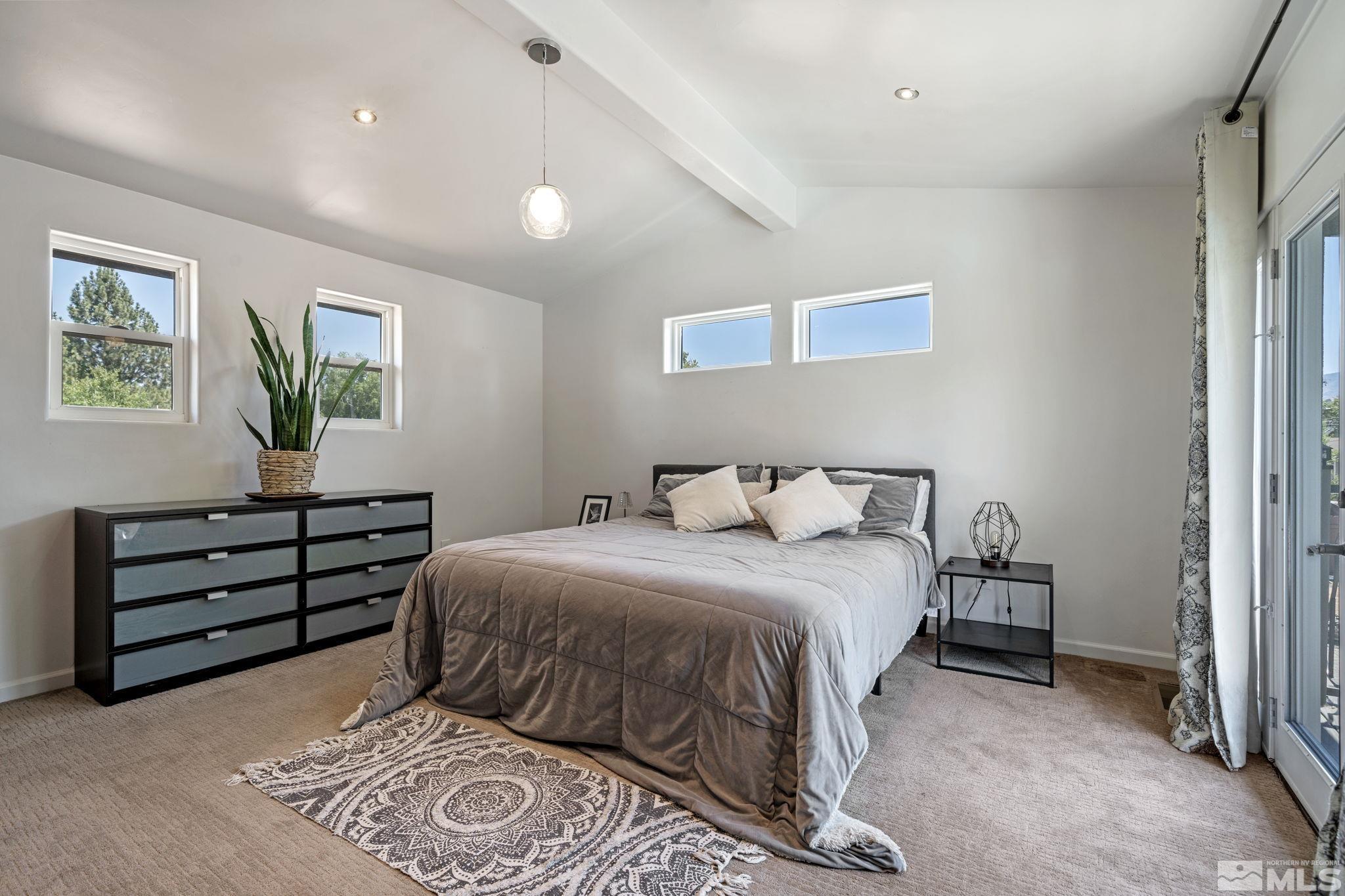 1005 Memory Lane Reno, NV 89509 - Photo 14 of 32 a bedroom with a bed and a window