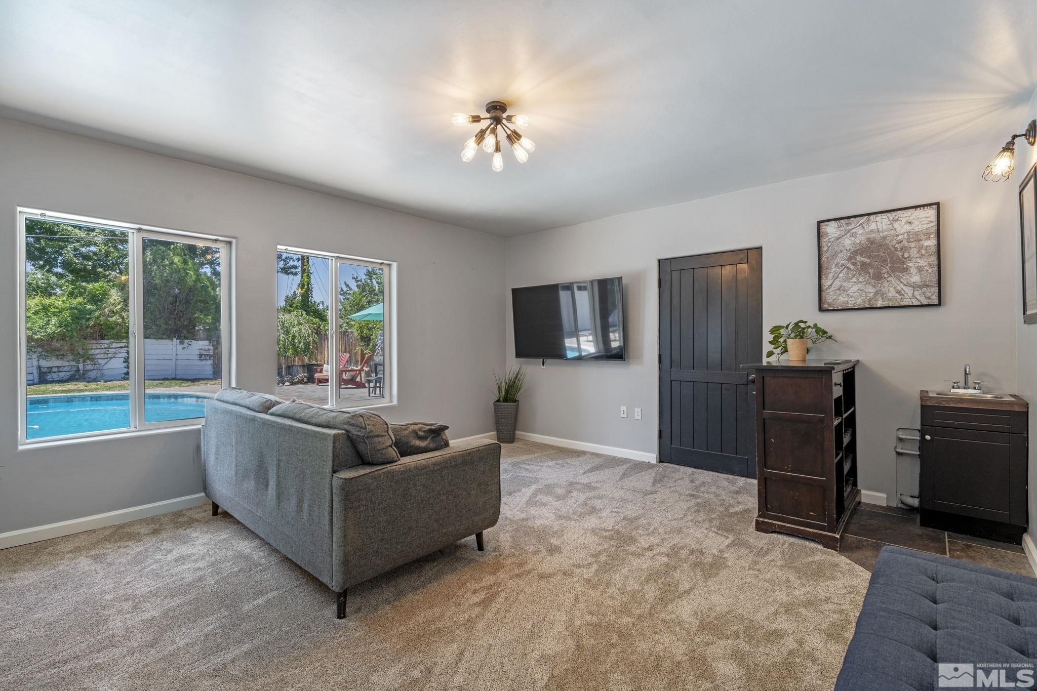 1005 Memory Lane Reno, NV 89509 - Photo 20 of 32 a living room with furniture and a flat screen tv