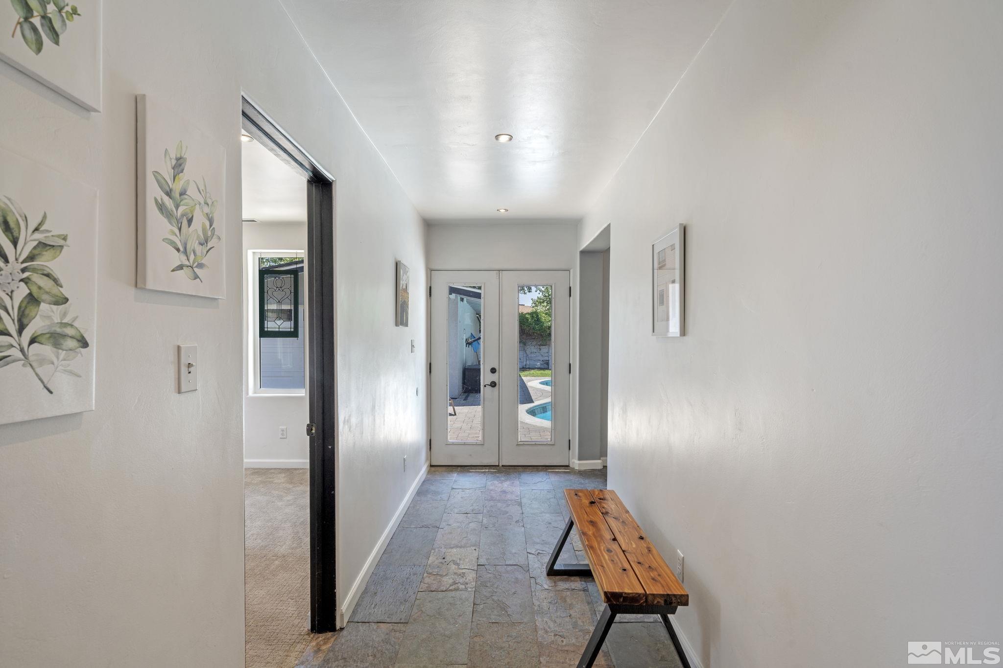 1005 Memory Lane Reno, NV 89509 - Photo 24 of 32 a very nice looking hallway with white walls and stairs