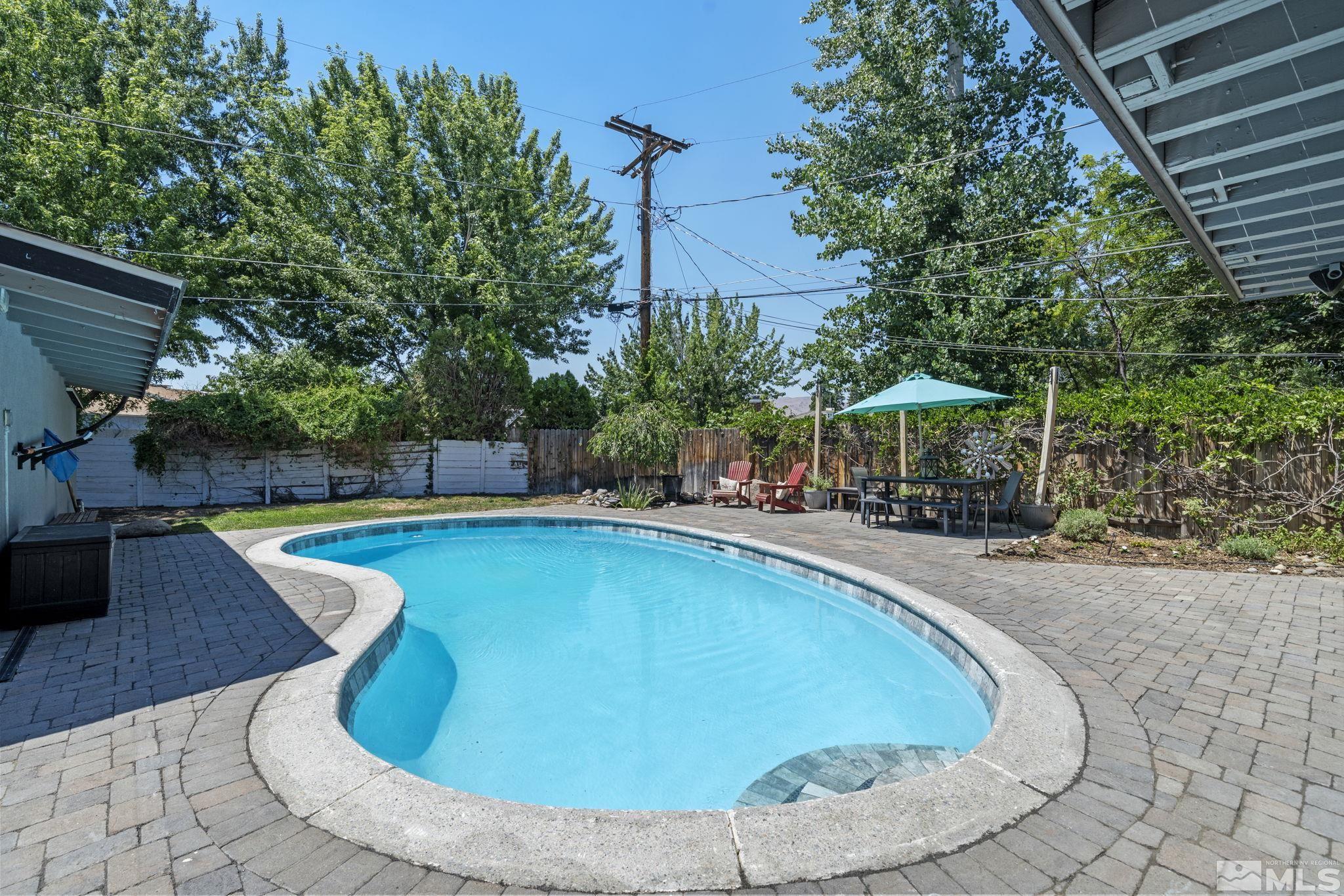 1005 Memory Lane Reno, NV 89509 - Photo 27 of 32 a view of a swimming pool with a patio