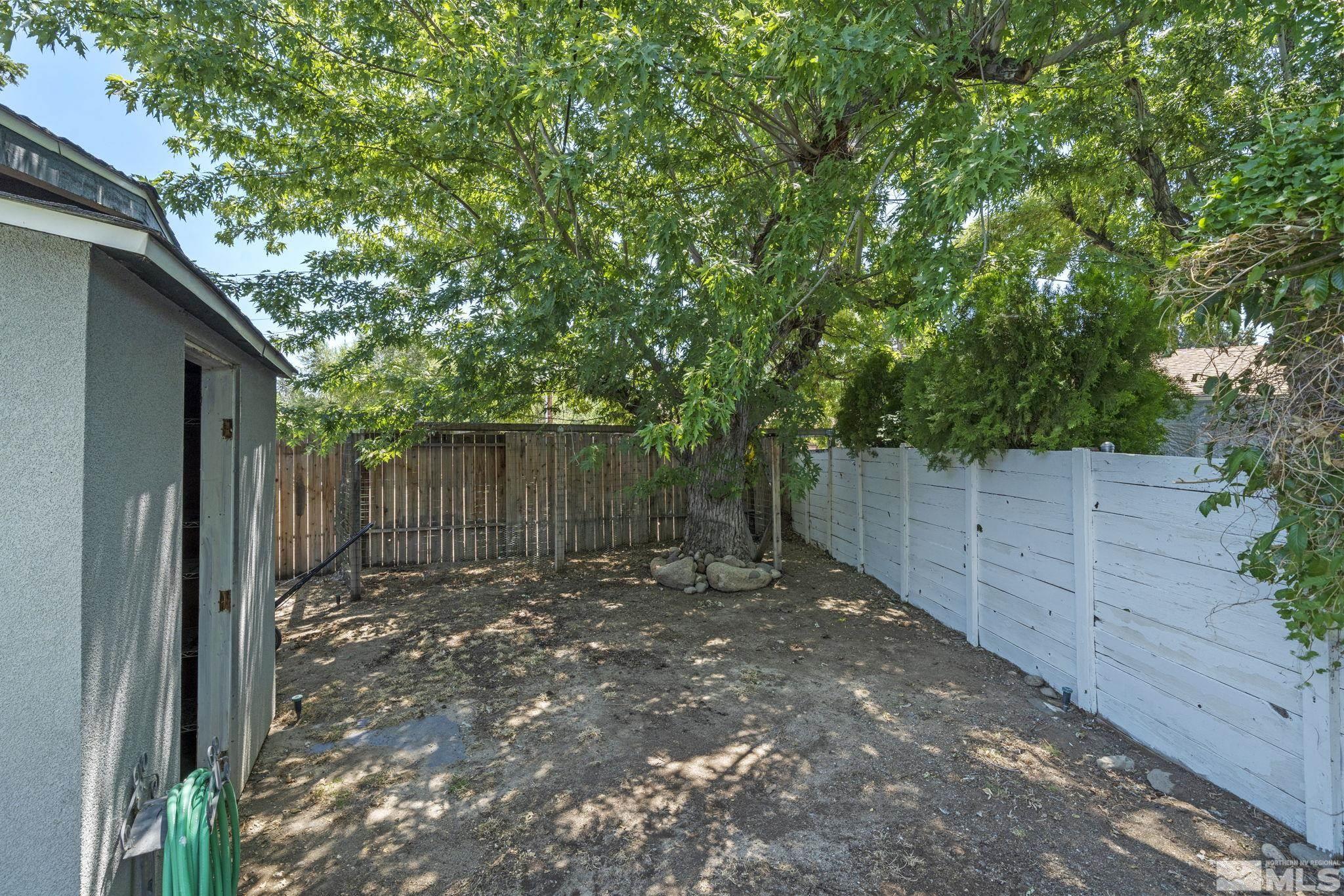 1005 Memory Lane Reno, NV 89509 - Photo 29 of 32 a backyard of a house with lots of green space