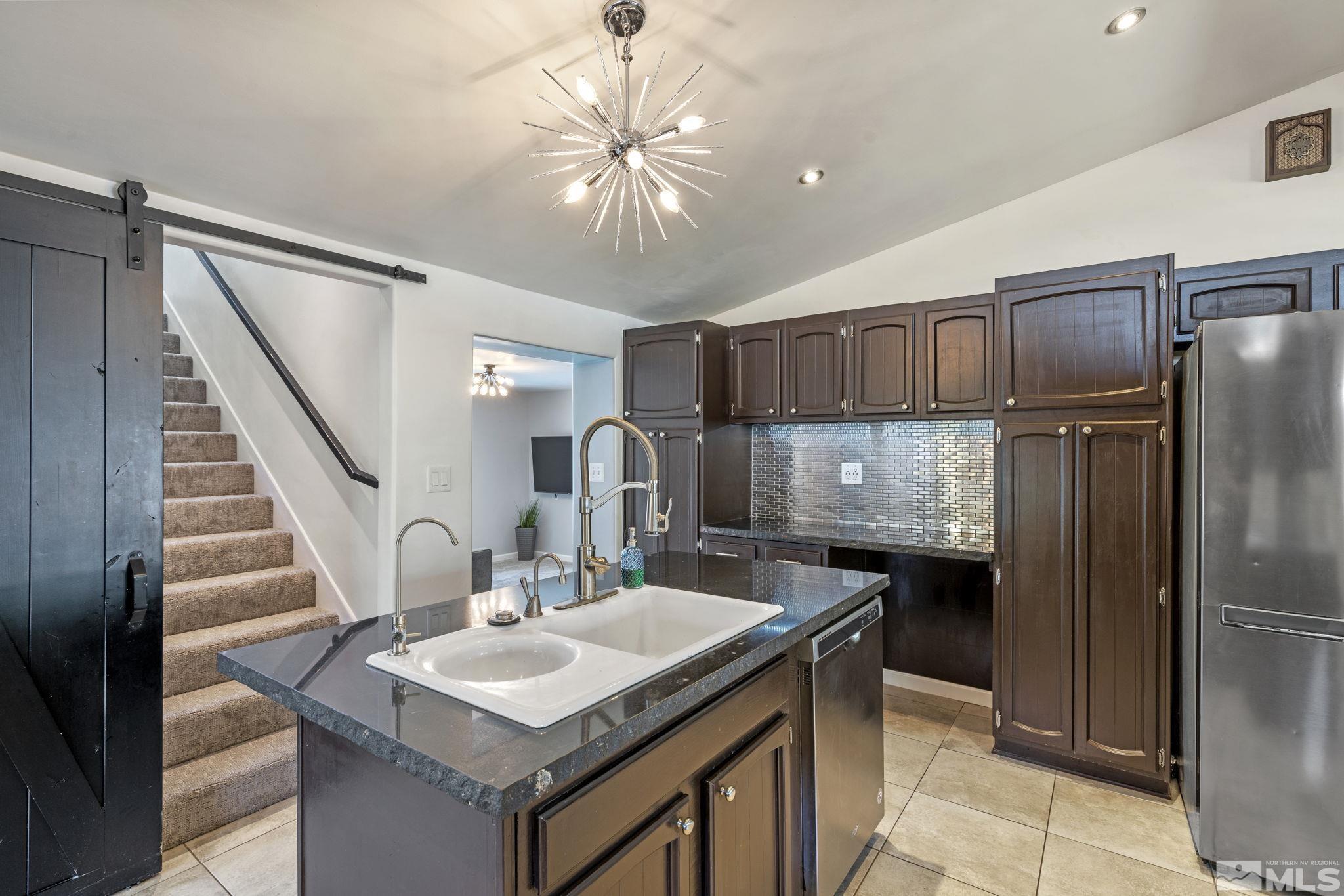 1005 Memory Lane Reno, NV 89509 - Photo 8 of 32 a kitchen with sink cabinets and refrigerator