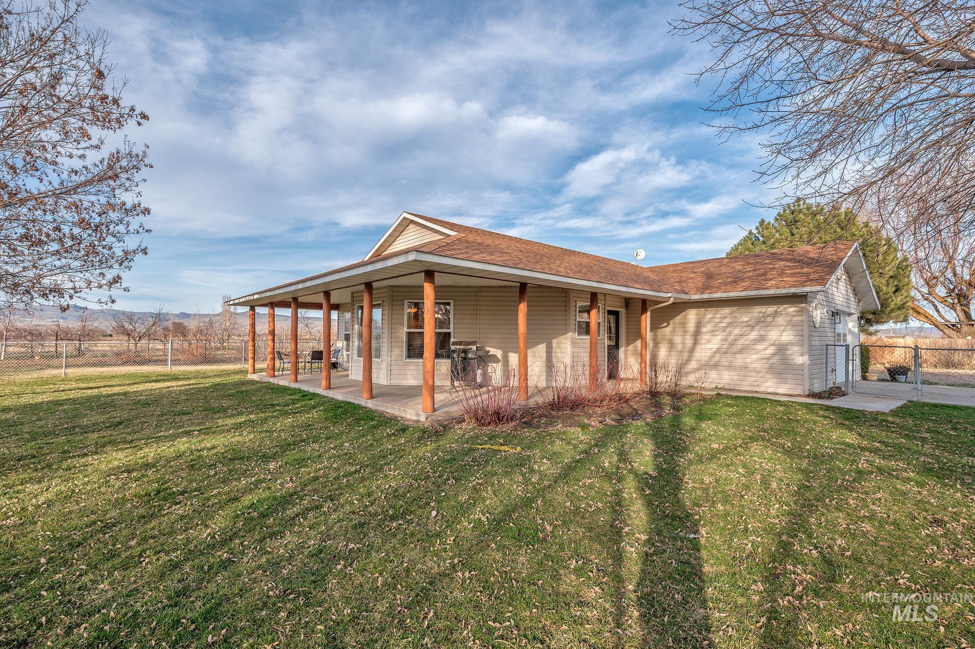 946 Indianhead Road Weiser, ID 83672 - Photo 1 of 36 Rear view of property with a large porch, a shingled roof, and a gate