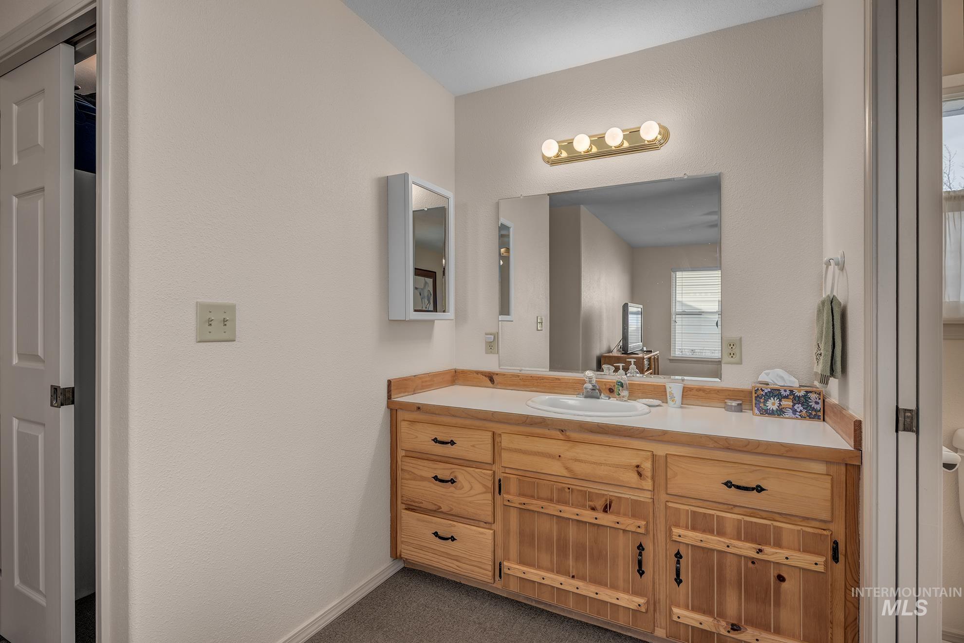 946 Indianhead Road Weiser, ID 83672 - Photo 14 of 36 Bathroom featuring vanity and dark colored carpet