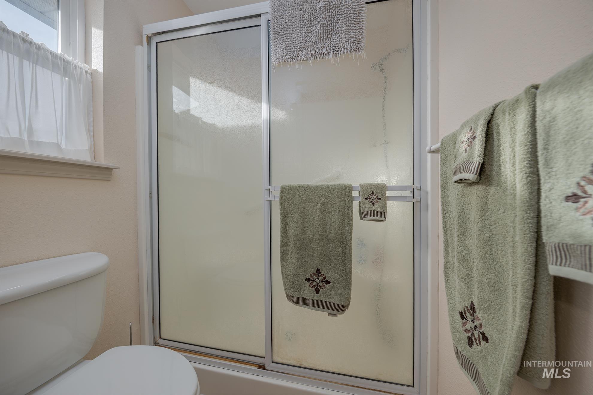 946 Indianhead Road Weiser, ID 83672 - Photo 15 of 36 Bathroom with a shower stall and healthy amount of natural light