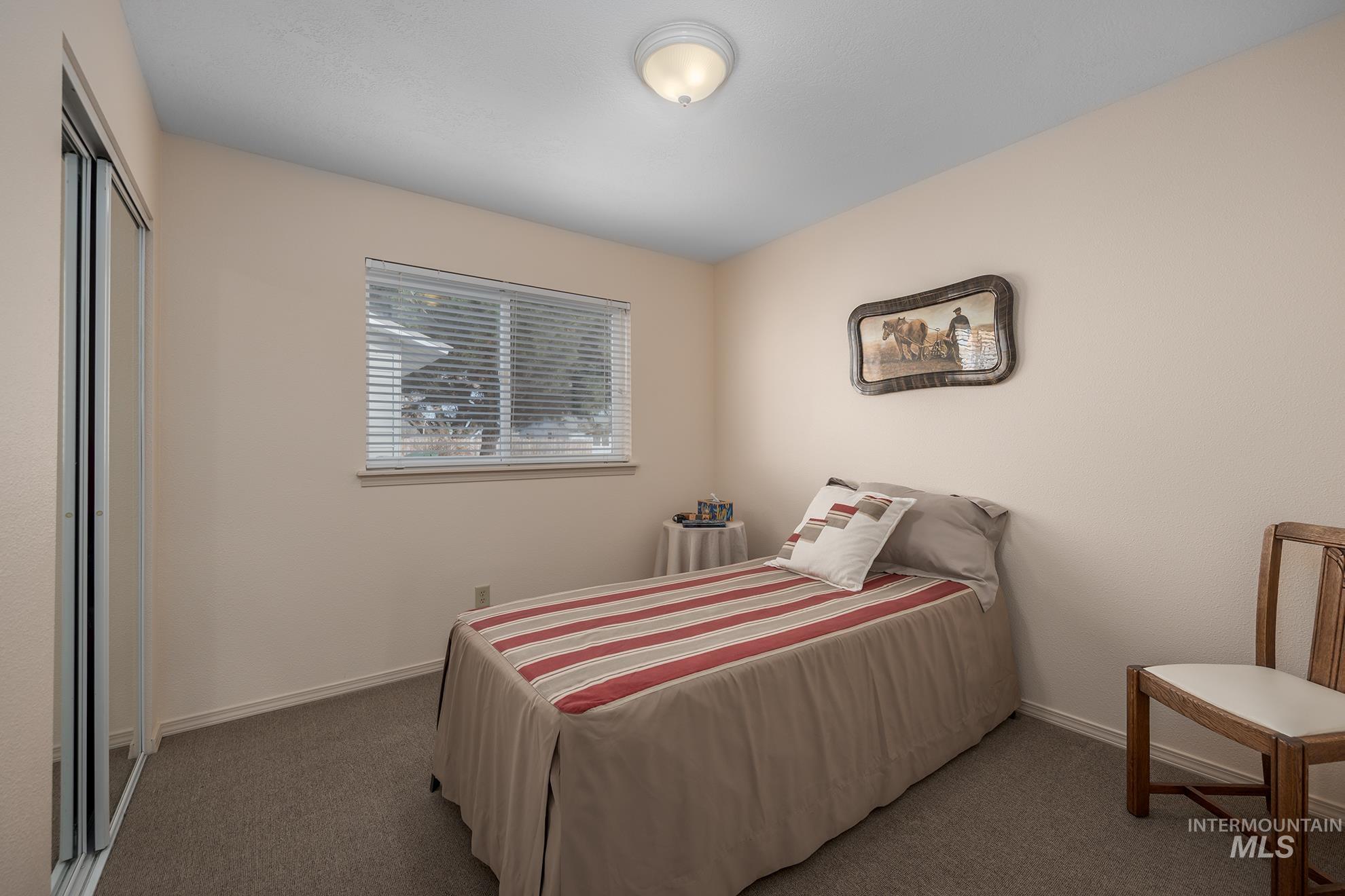 946 Indianhead Road Weiser, ID 83672 - Photo 17 of 36 Bedroom featuring dark carpet and a closet