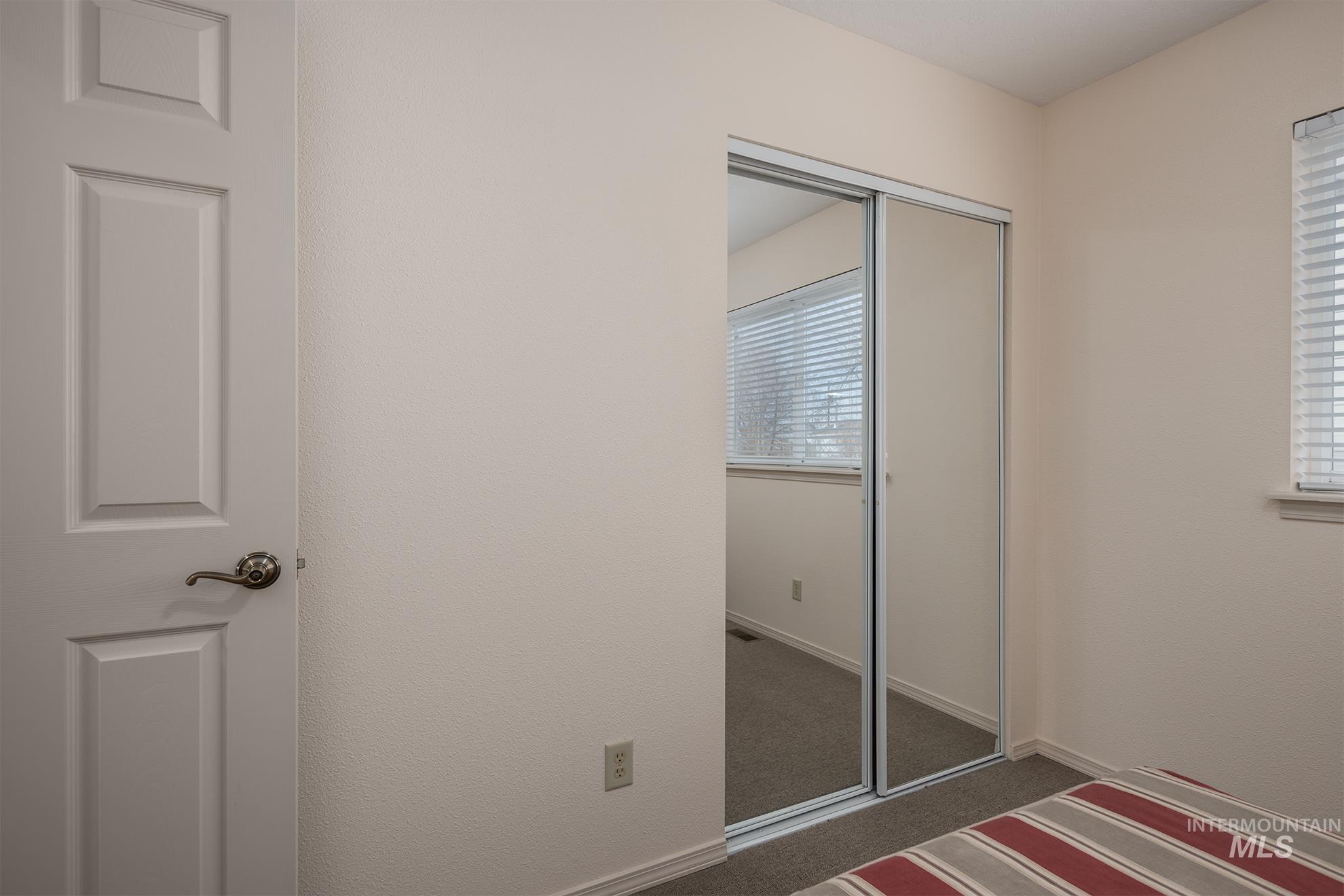 946 Indianhead Road Weiser, ID 83672 - Photo 18 of 36 Unfurnished bedroom with dark colored carpet and a closet