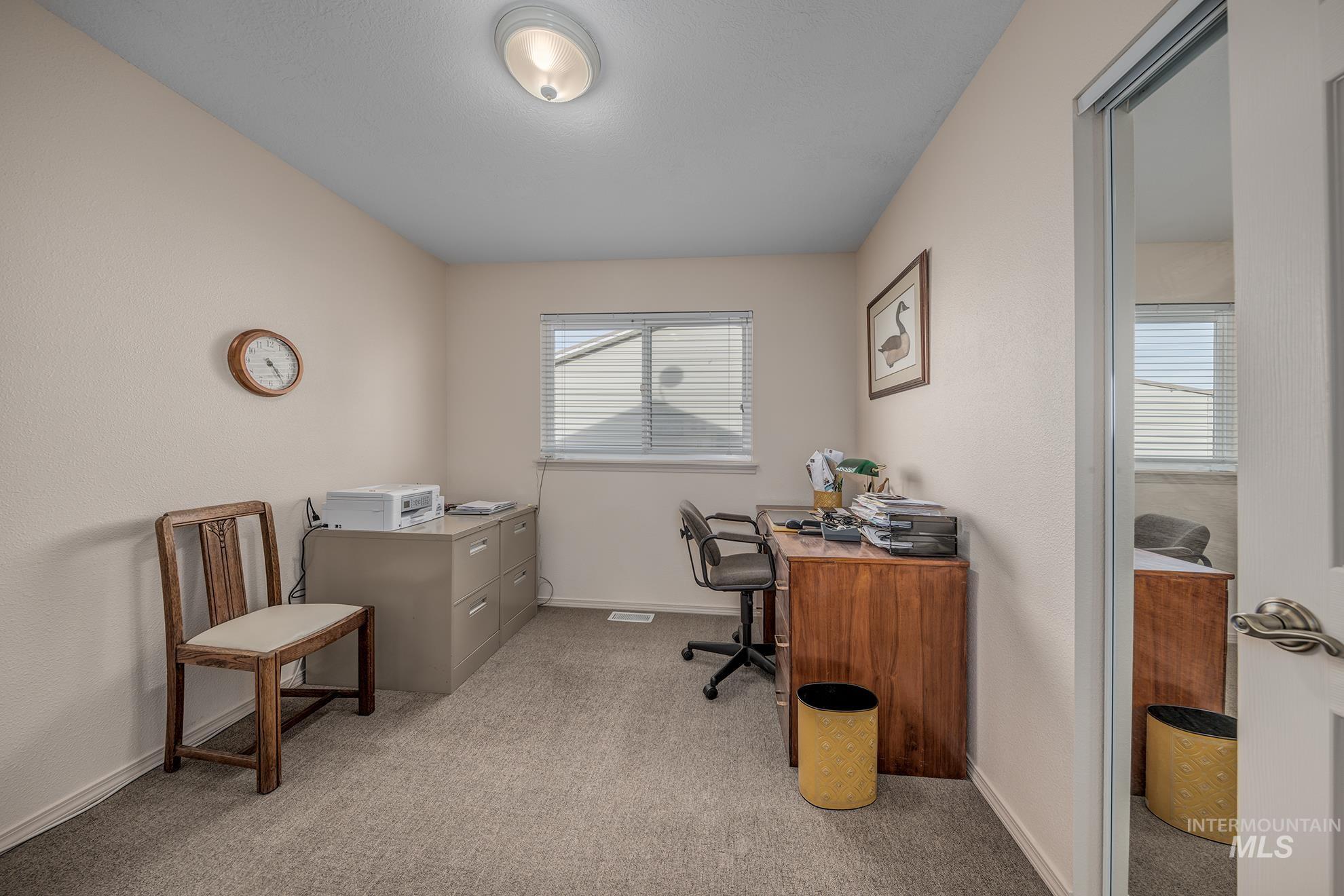 946 Indianhead Road Weiser, ID 83672 - Photo 19 of 36 Office area featuring light carpet and baseboards