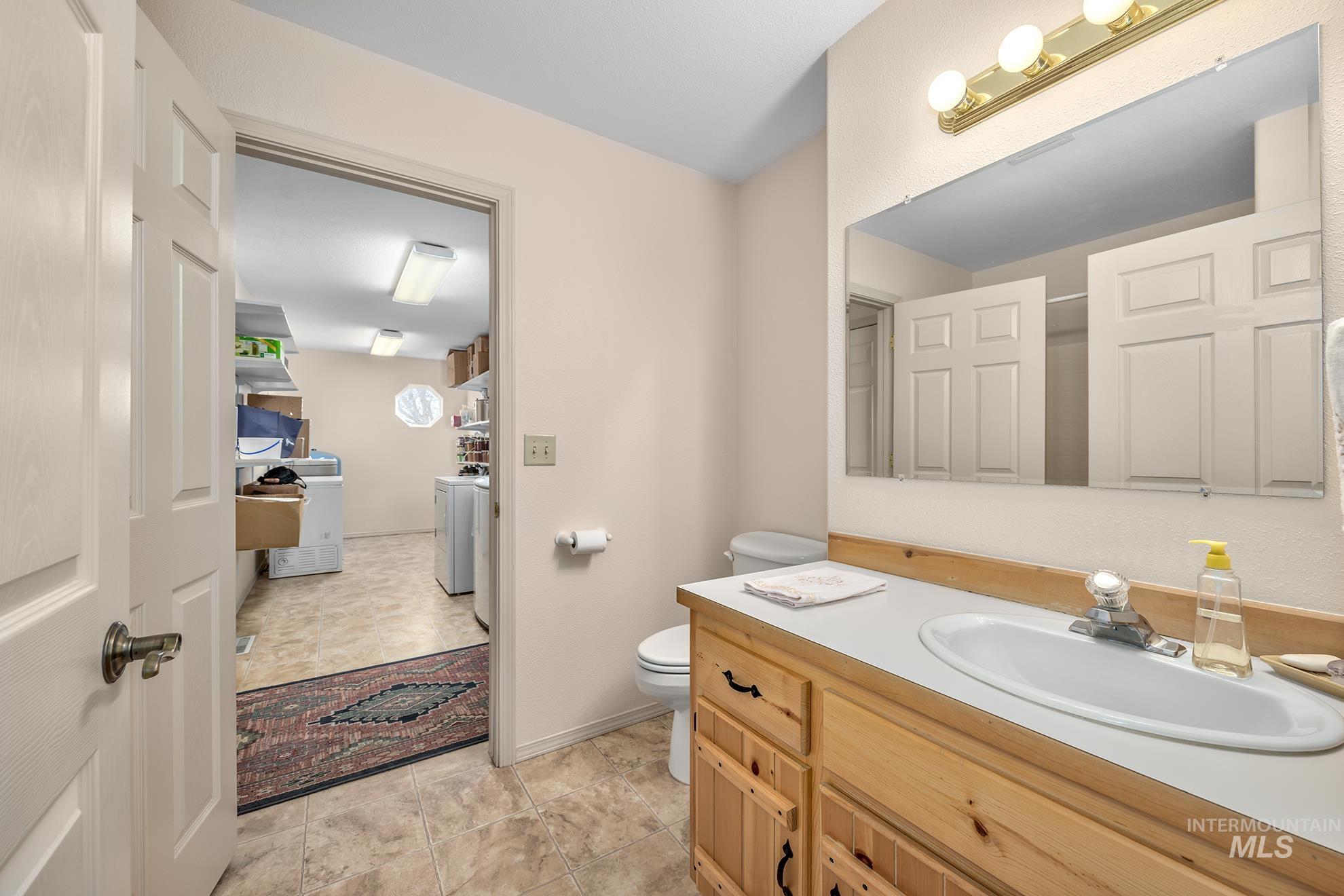 946 Indianhead Road Weiser, ID 83672 - Photo 21 of 36 Bathroom with vanity and separate washer and dryer