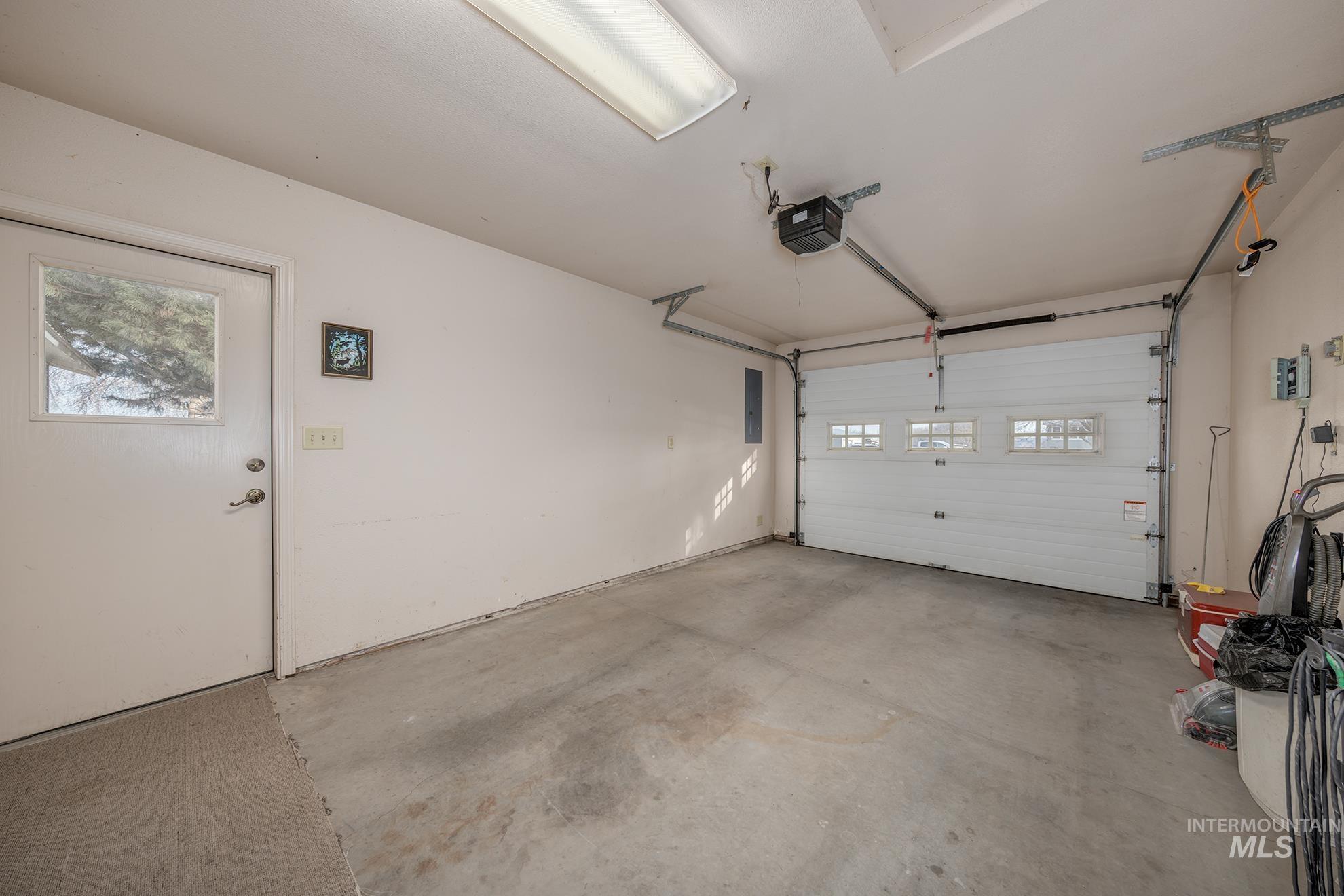 946 Indianhead Road Weiser, ID 83672 - Photo 23 of 36 Garage featuring a garage door opener and electric panel