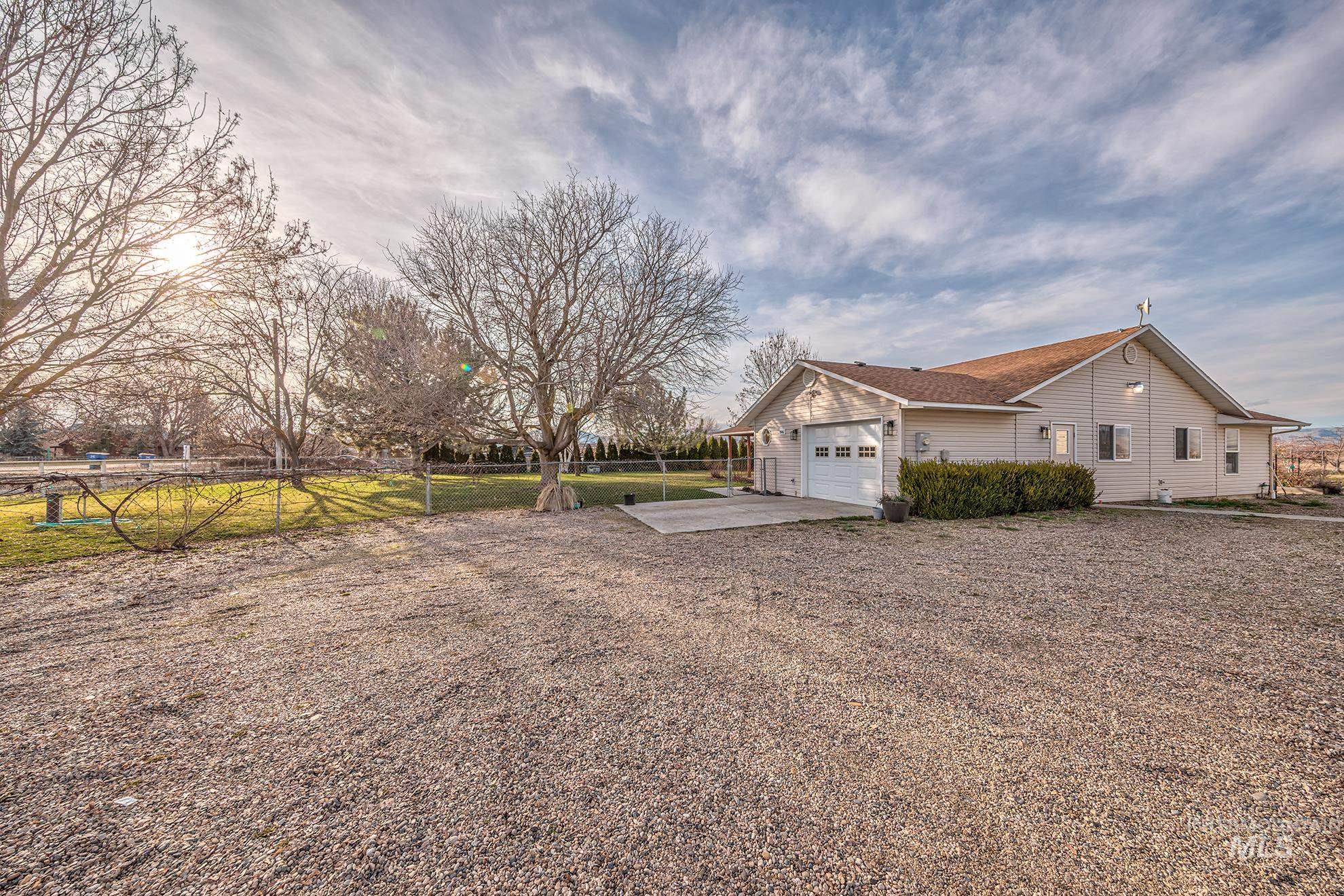 946 Indianhead Road Weiser, ID 83672 - Photo 27 of 36 View of side of home with driveway, a patio, and an attached garage