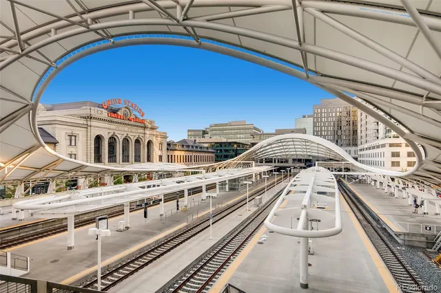 a view of a balcony with two chairs and a stove