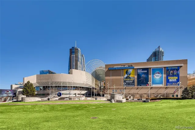 a view of a house with a big yard and large trees