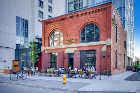 a group of people sitting in front of a building