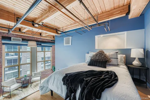 a bed sitting in a bedroom next to a large window