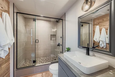 a bathroom with a sink and a mirror with shower