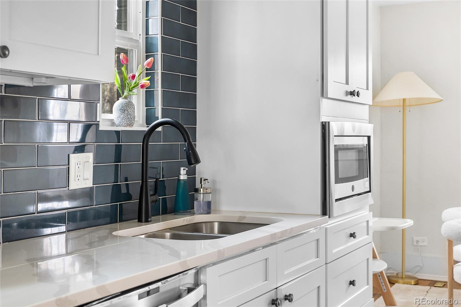 1445 Ash Street Denver, CO 80220 - Photo 13 of 45 a kitchen with a refrigerator and a sink