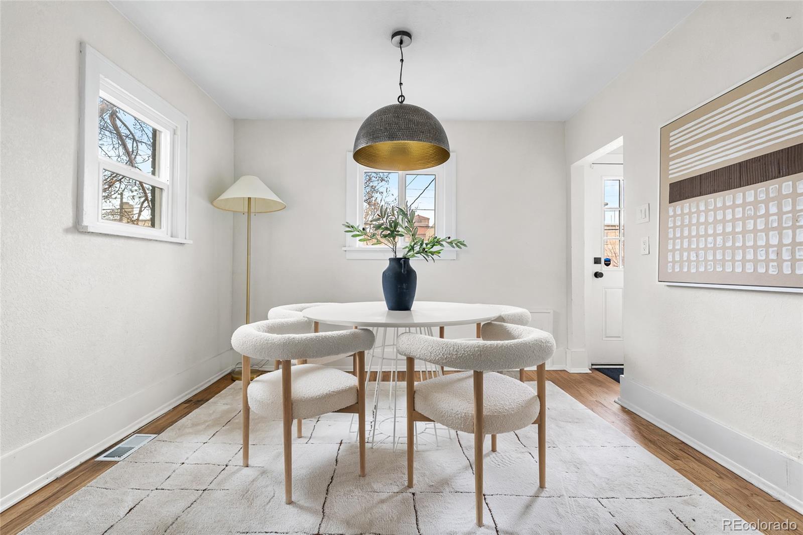 1445 Ash Street Denver, CO 80220 - Photo 19 of 45 a dining room with furniture and wooden floor