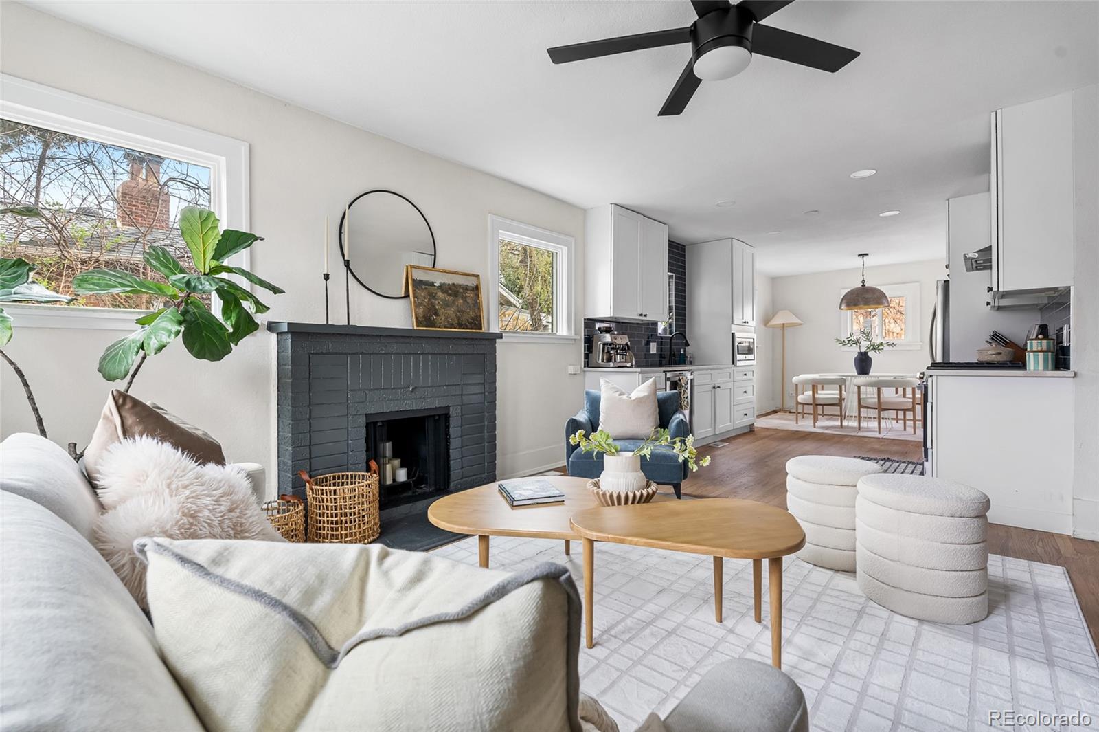 1445 Ash Street Denver, CO 80220 - Photo 21 of 45 a living room with furniture a fireplace and a floor to ceiling window