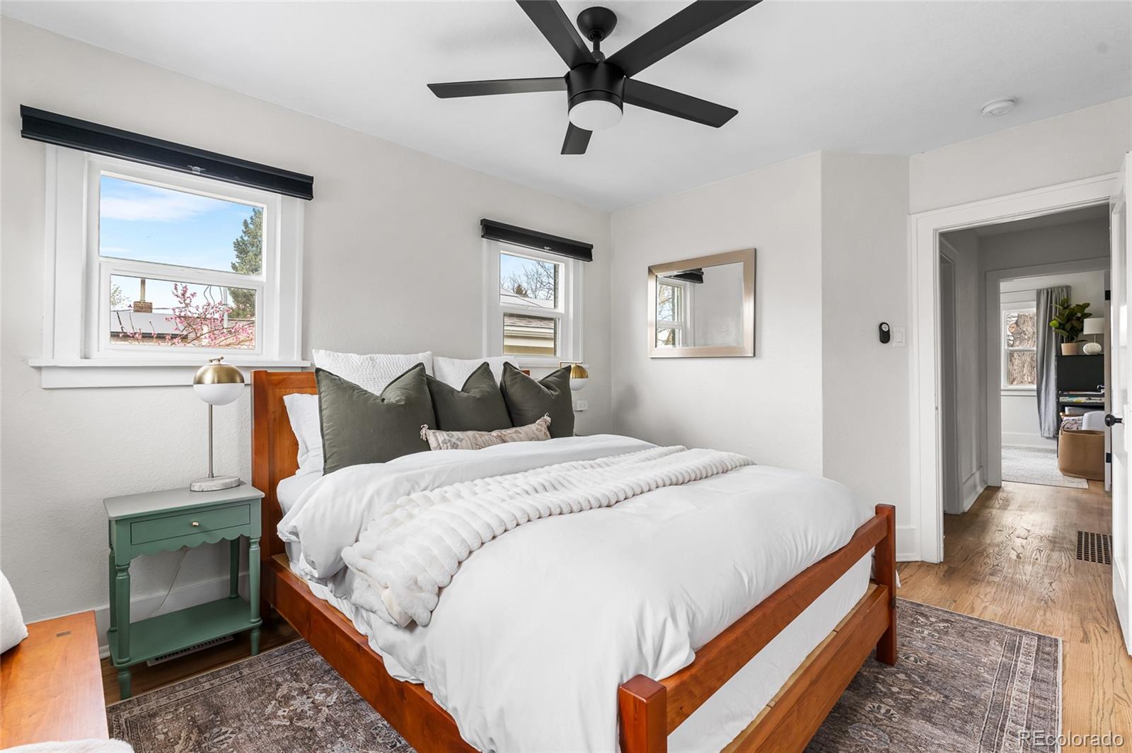 1445 Ash Street Denver, CO 80220 - Photo 28 of 45 a bed room with a bed and a painting on the wall