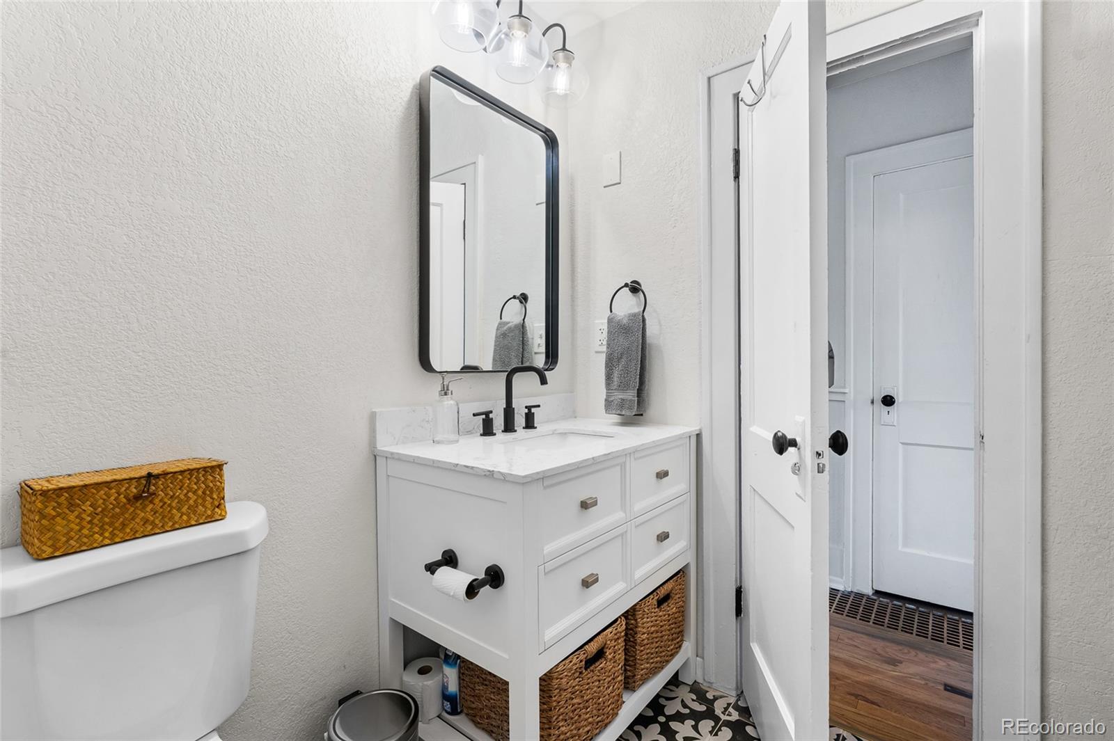 1445 Ash Street Denver, CO 80220 - Photo 30 of 45 a bathroom with a sink a toilet and shower