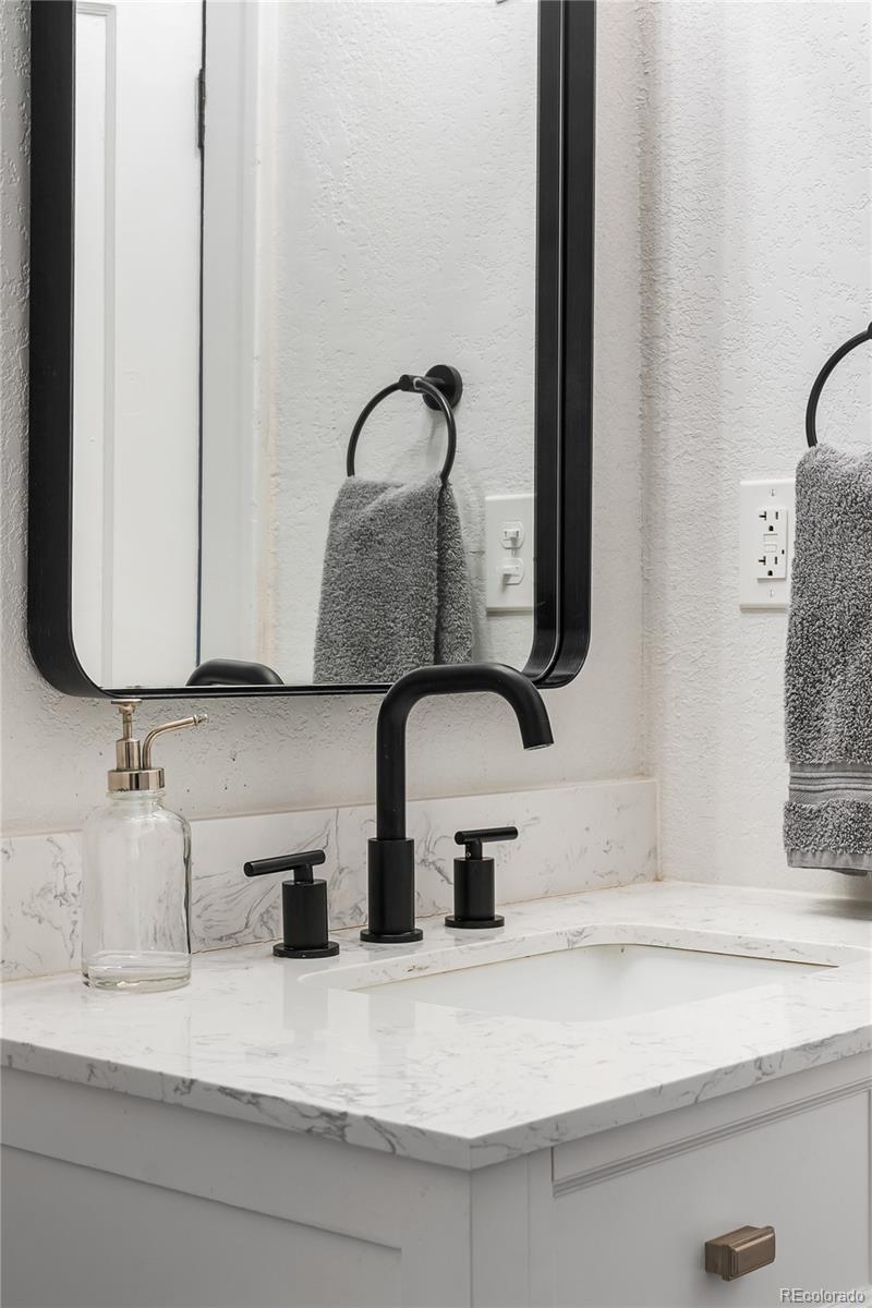 1445 Ash Street Denver, CO 80220 - Photo 31 of 45 a bathroom with a sink and a mirror