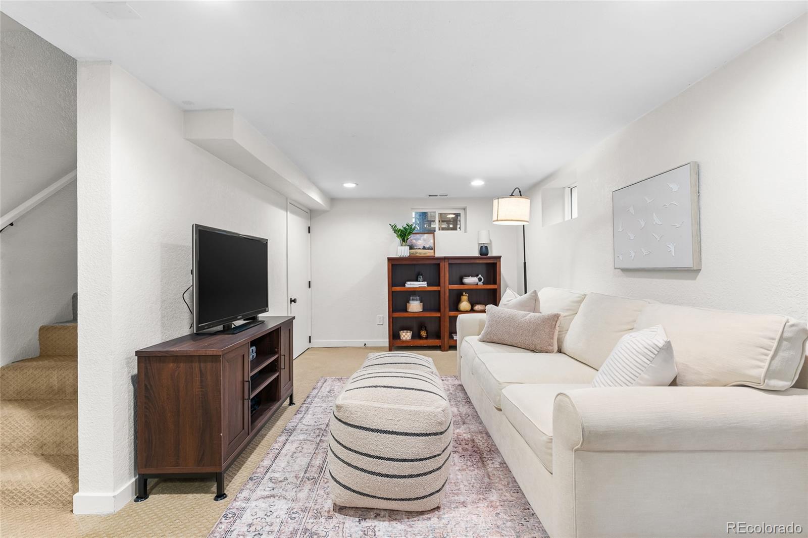 1445 Ash Street Denver, CO 80220 - Photo 32 of 45 a living room with furniture and a flat screen tv