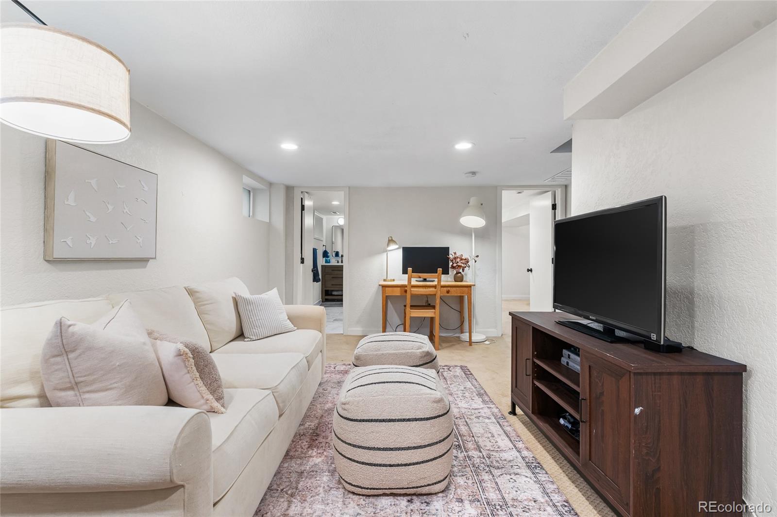 1445 Ash Street Denver, CO 80220 - Photo 34 of 45 a living room with furniture and a flat screen tv