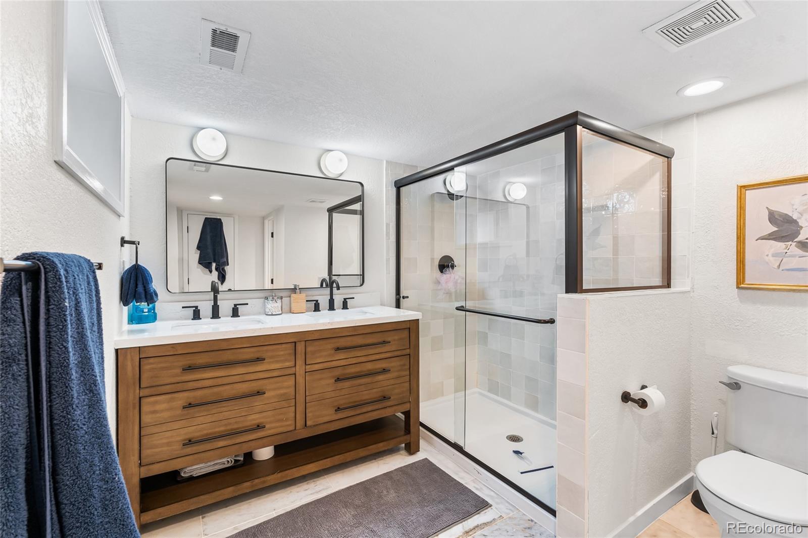 1445 Ash Street Denver, CO 80220 - Photo 35 of 45 a bathroom with a double vanity sink toilet and shower