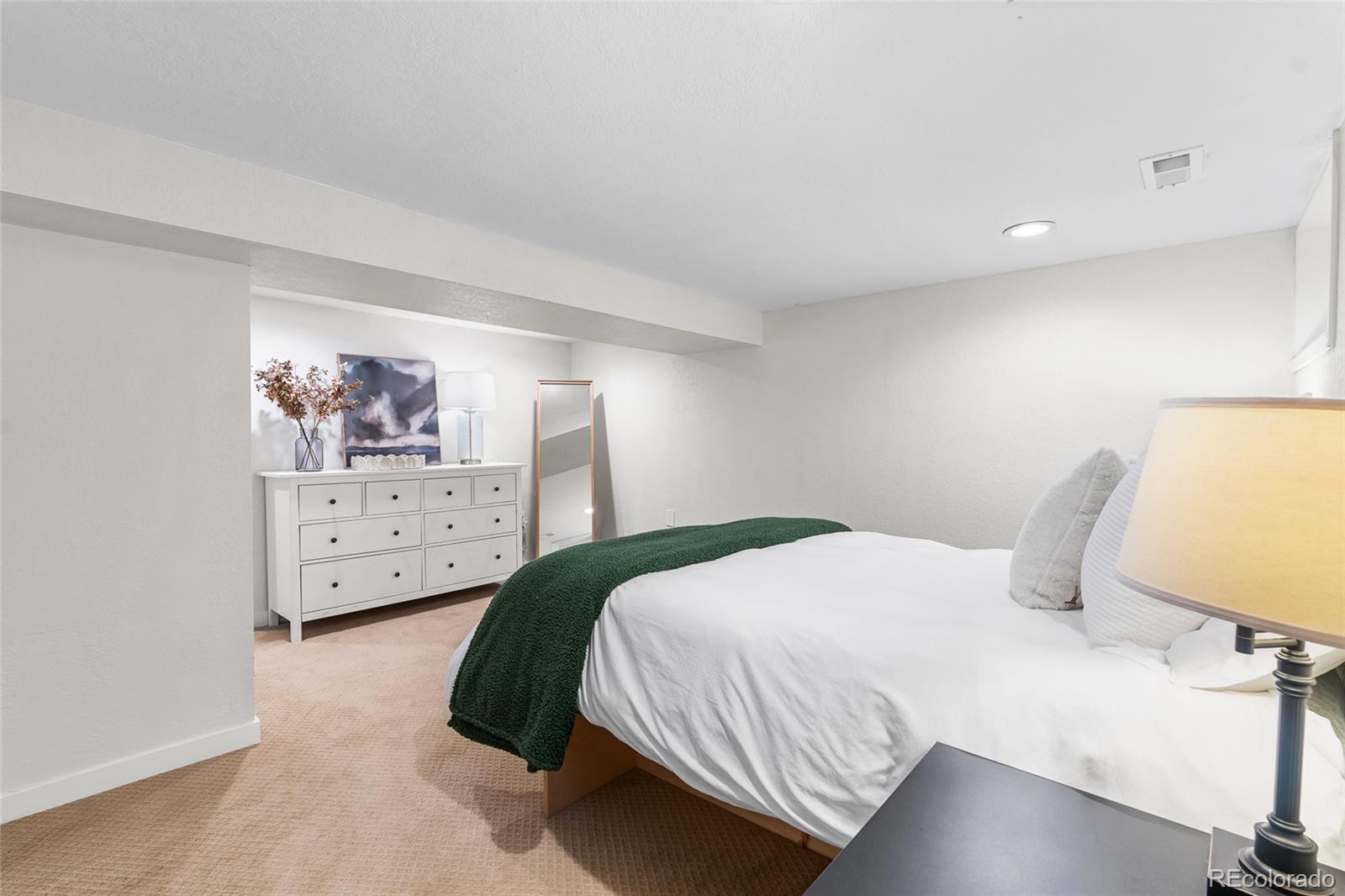 1445 Ash Street Denver, CO 80220 - Photo 37 of 45 a bedroom with a bed and lamp