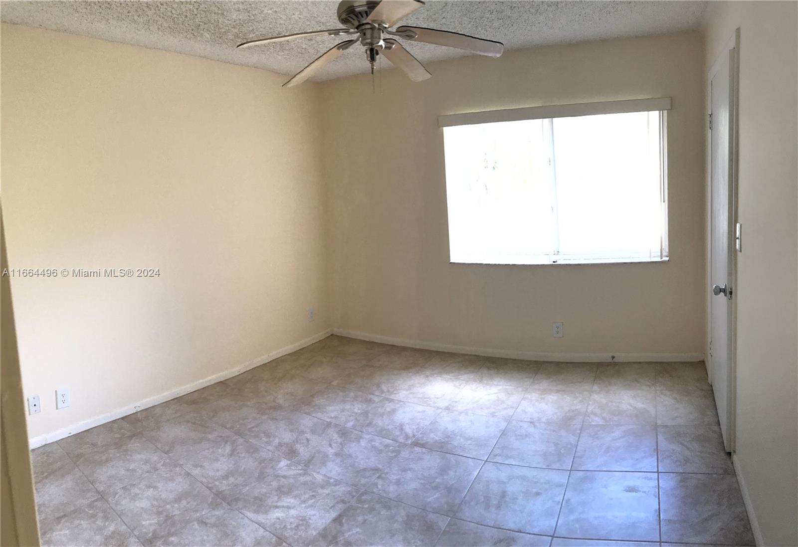 5672 Rock Island Road, Unit 259 Tamarac, FL 33319 - Photo 13 of 31 an empty room with a window