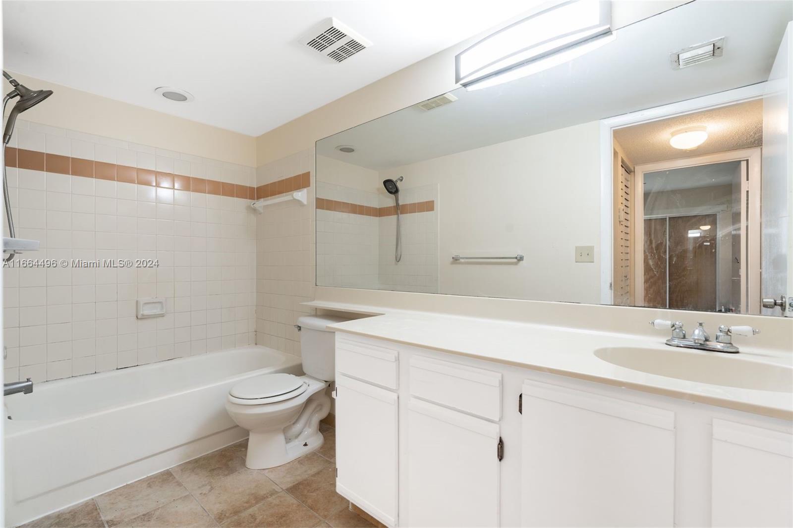 5672 Rock Island Road, Unit 259 Tamarac, FL 33319 - Photo 19 of 31 a bathroom with a sink a toilet and shower