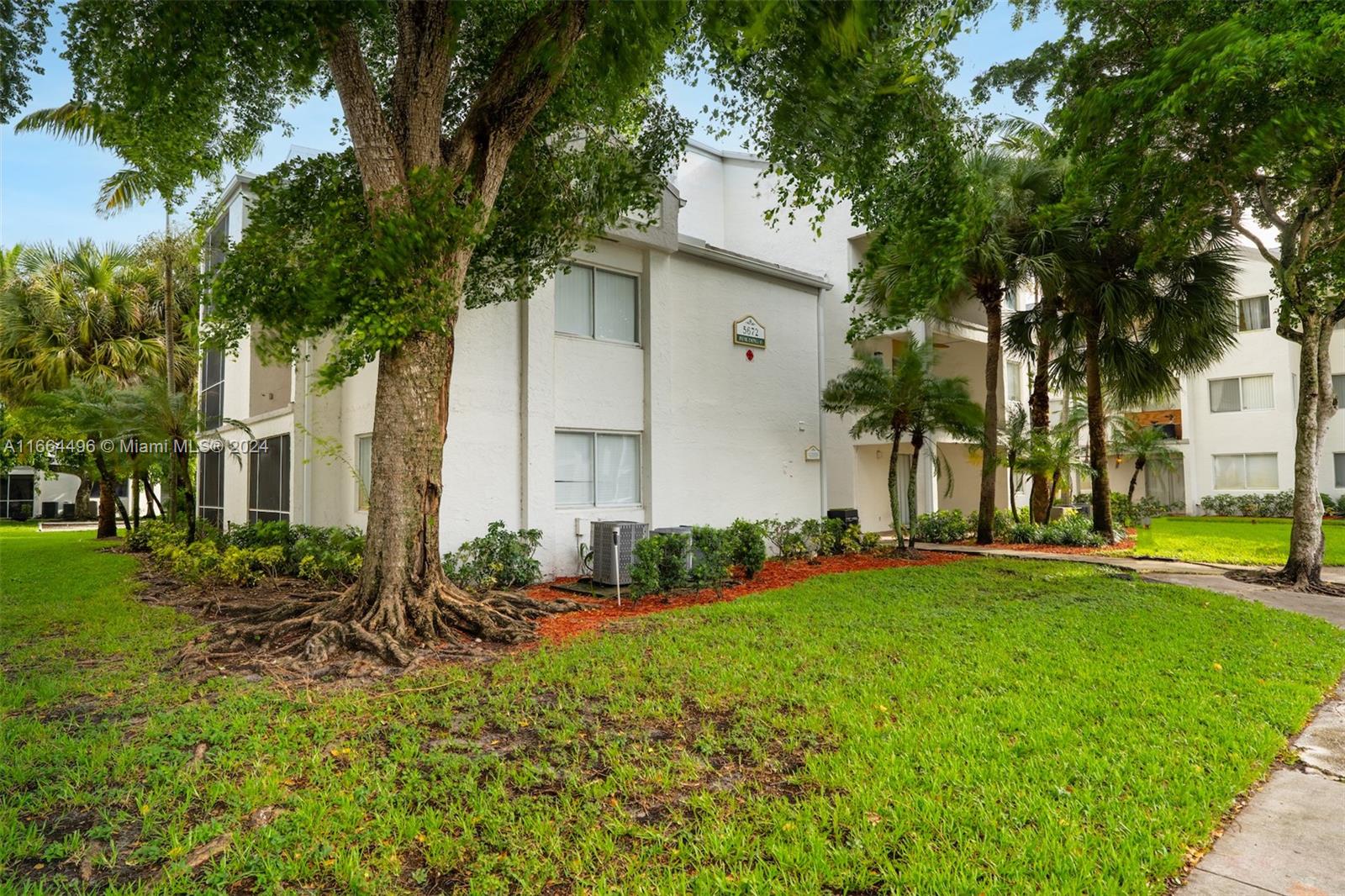 5672 Rock Island Road, Unit 259 Tamarac, FL 33319 - Photo 21 of 31 a front view of a house with a yard