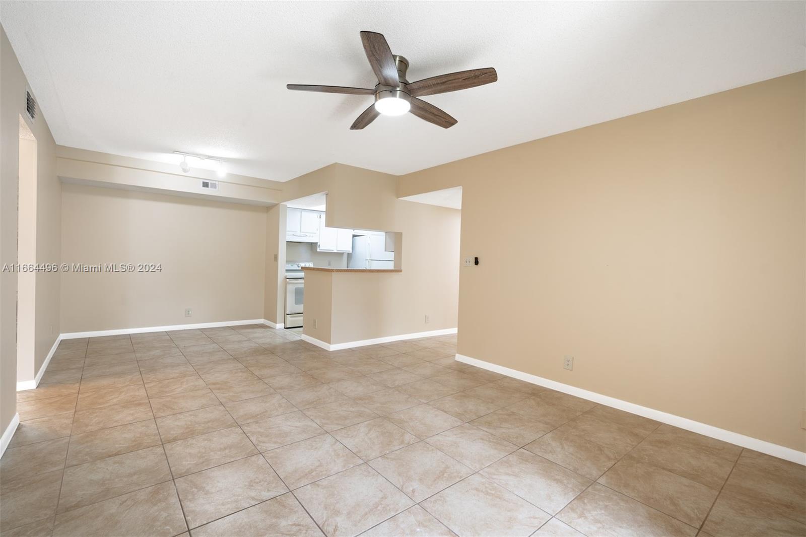 5672 Rock Island Road, Unit 259 Tamarac, FL 33319 - Photo 3 of 31 a view of a livingroom with a ceiling fan and wooden floor