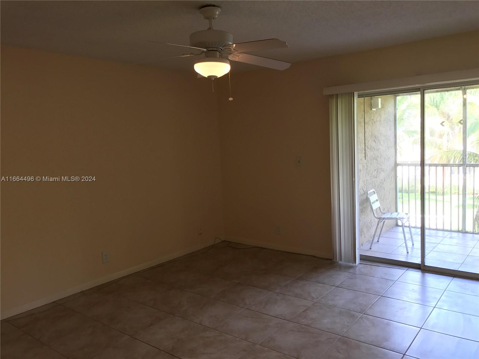 5672 Rock Island Road, Unit 259 Tamarac, FL 33319 - Photo 4 of 31 a view of an empty room with a window