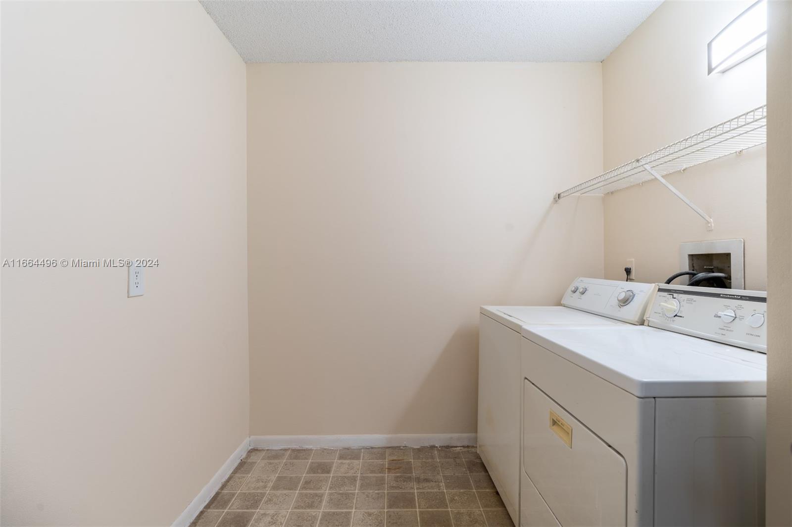 5672 Rock Island Road, Unit 259 Tamarac, FL 33319 - Photo 6 of 31 a utility room with dryer and washer
