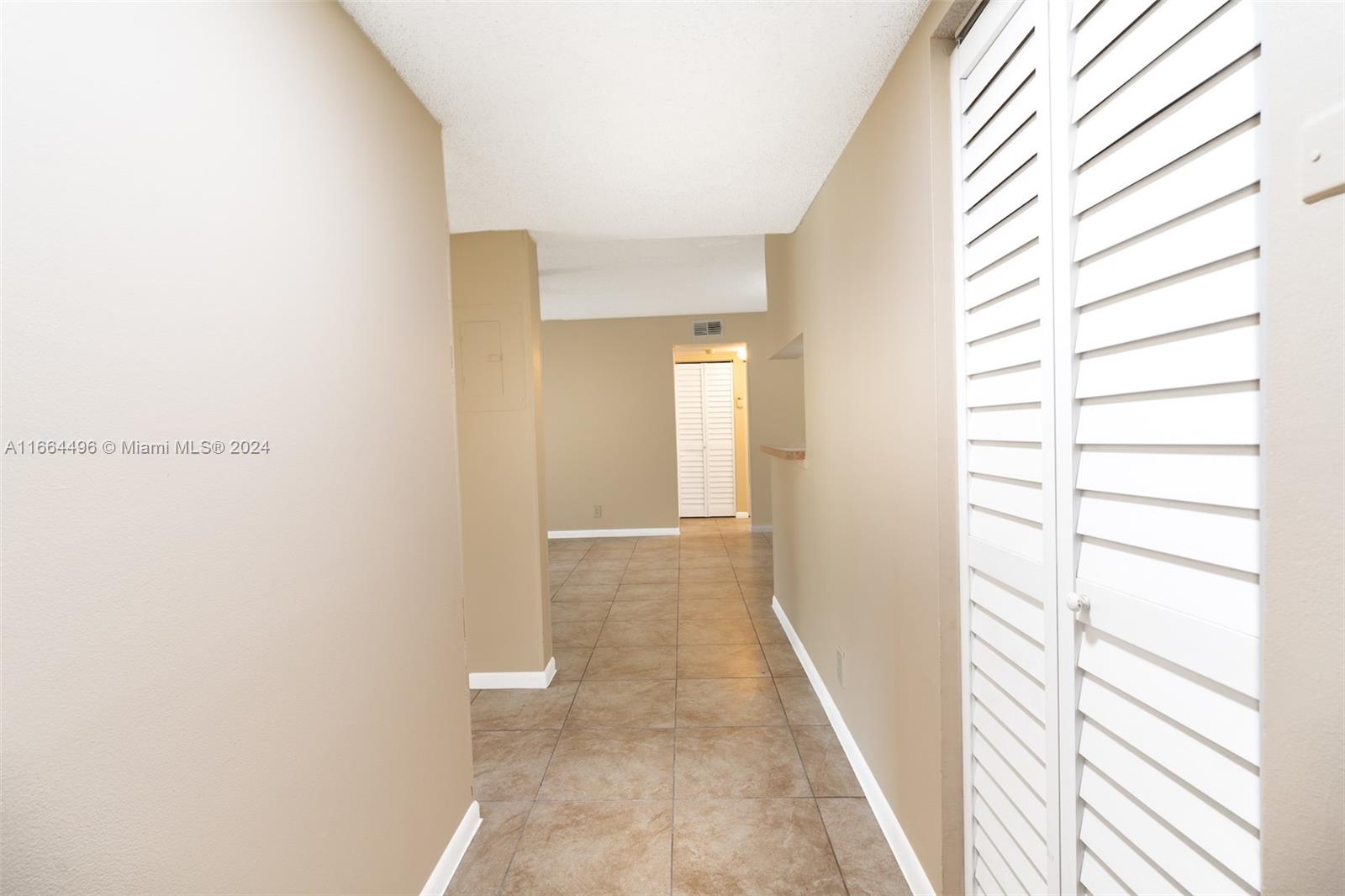 5672 Rock Island Road, Unit 259 Tamarac, FL 33319 - Photo 9 of 31 a view of a room with a white wall and a window